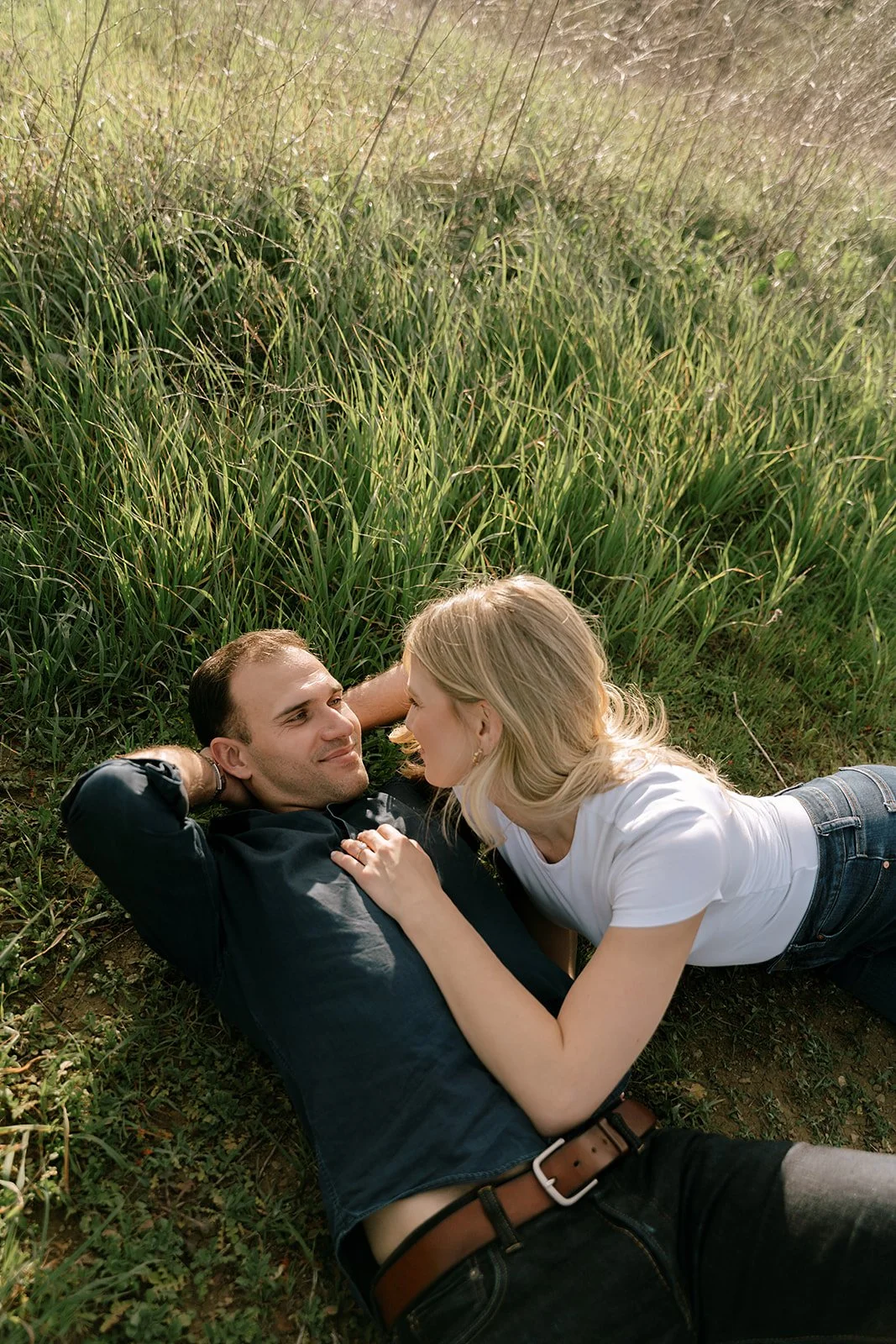 Malibu Engagement Session, Couple lying in a grassy field