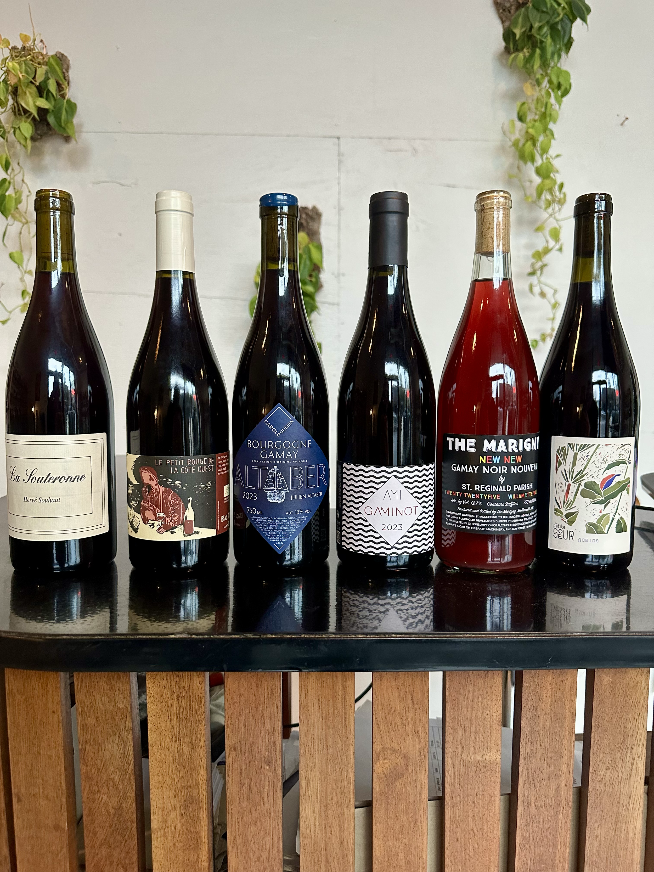 Assorted bottles of light red Gamay wines from France and the Willamette Valley