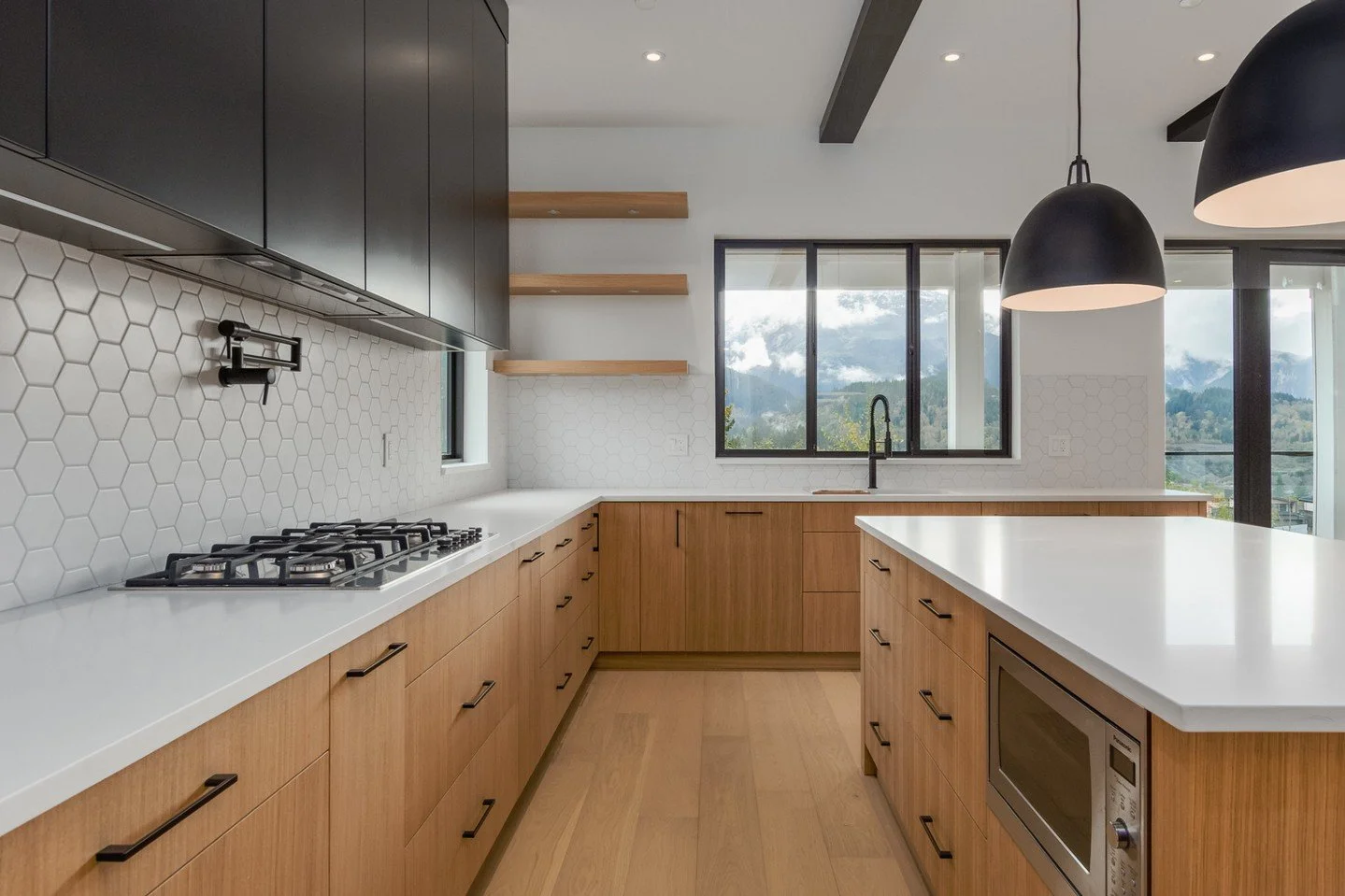 Warm wood tones, striking contrast, and clean architectural detailing create a kitchen that feels both elevated and inviting. 

Thoughtfully layered materials and refined finishes bring a sense of effortless luxury while maintaining everyday function