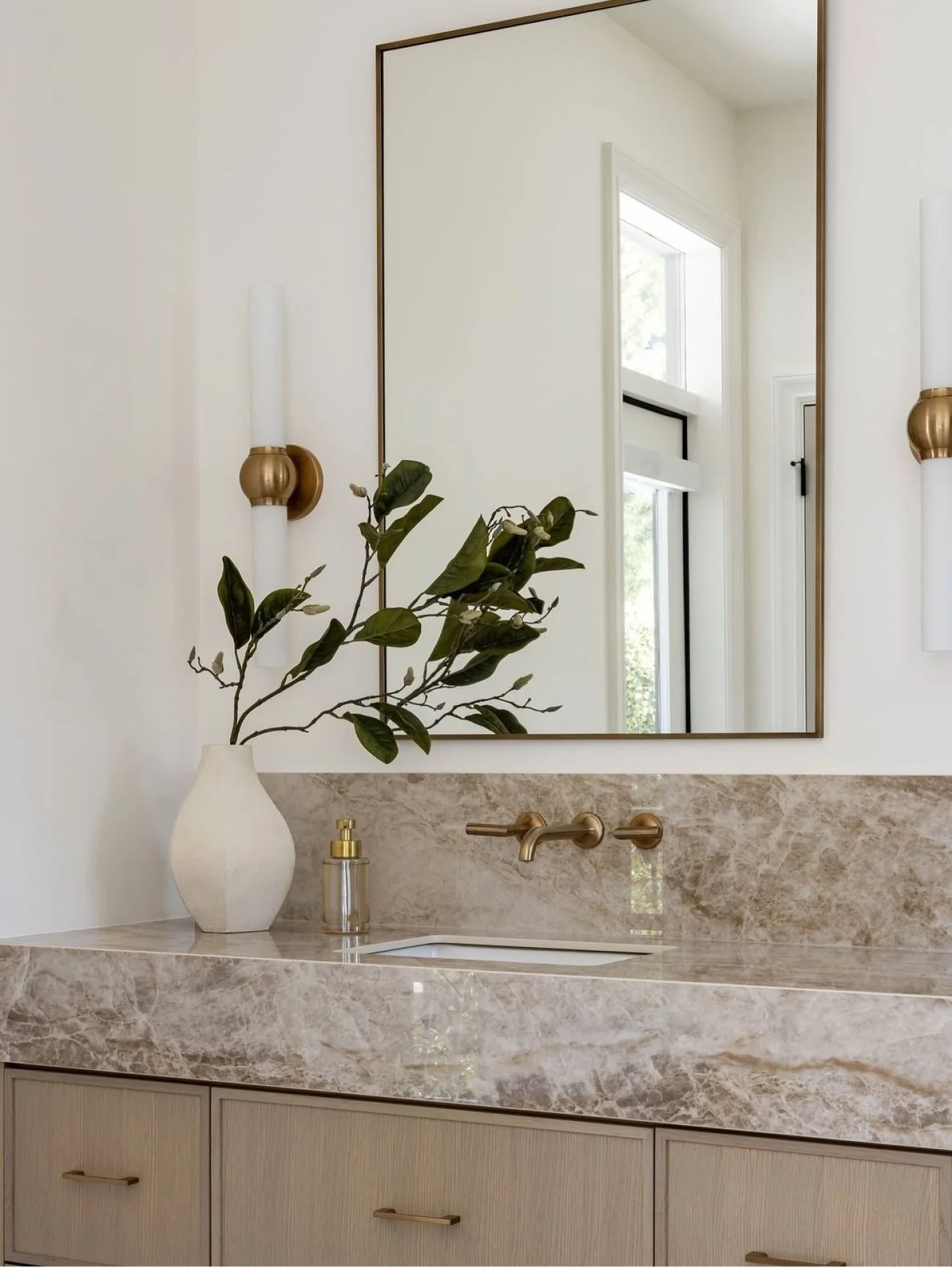 Refined materiality, warm brass accents, and softly layered neutrals create a bathroom that feels both timeless and understated. The beauty is found in the balance of texture, tone, and intentional simplicity. 

Let&rsquo;s bring your vision to life.