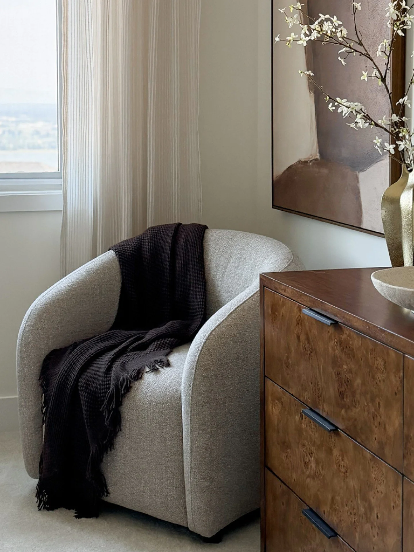 A glimpse into the primary bedroom at The Vault.

Soft upholstery, rich burl wood, custom feature wall, warm stone, and deep chocolate accents create a layered, tailored retreat with just enough contrast to give the room depth.

More from The Vault, 