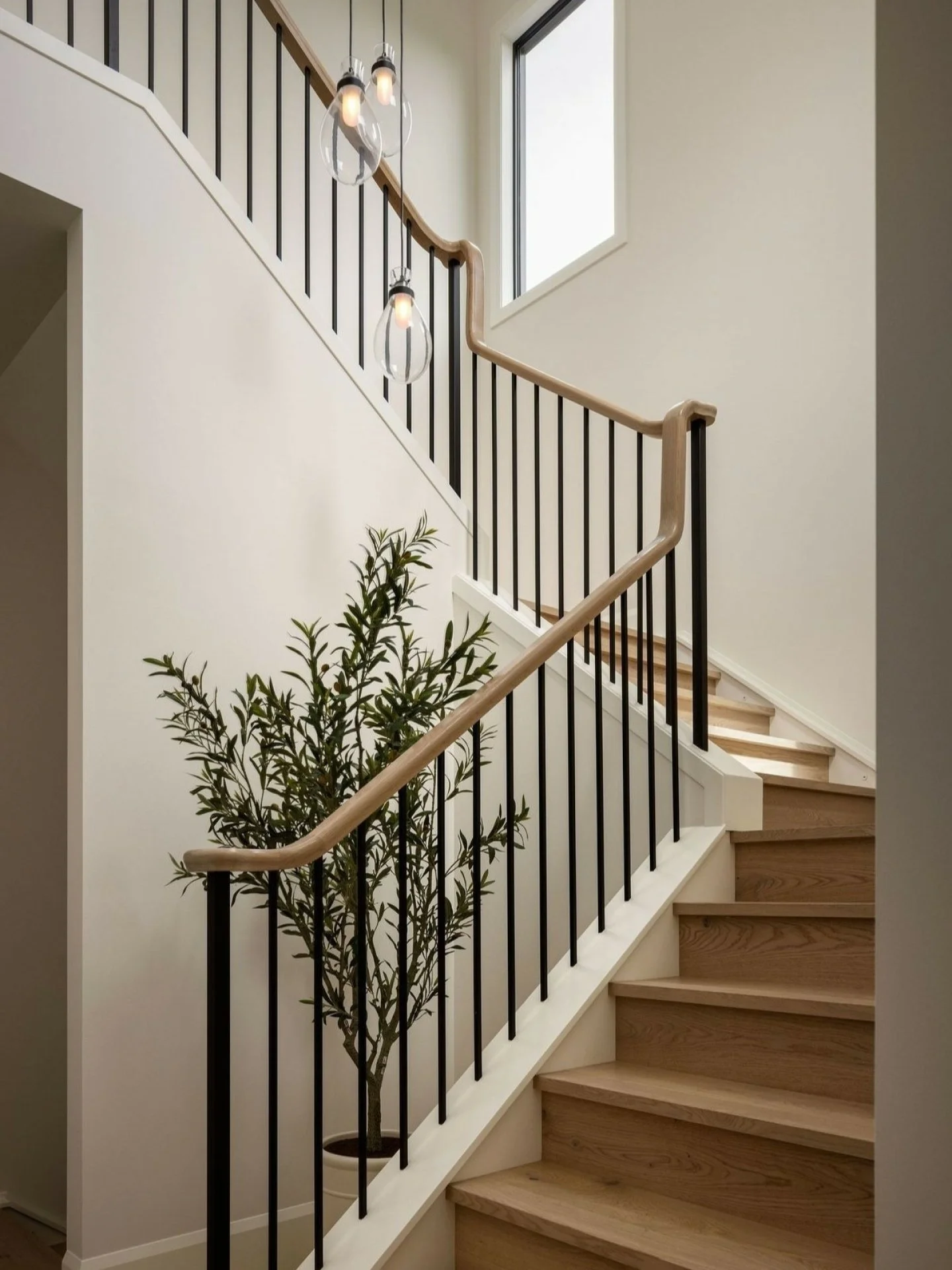 The kind of detail that quietly defines a home. Warm oak, fine black balusters and sculptural lighting bring contrast to an otherwise restrained palette, turning a hardworking stairwell into something considered from every angle.

#interiordesign #st