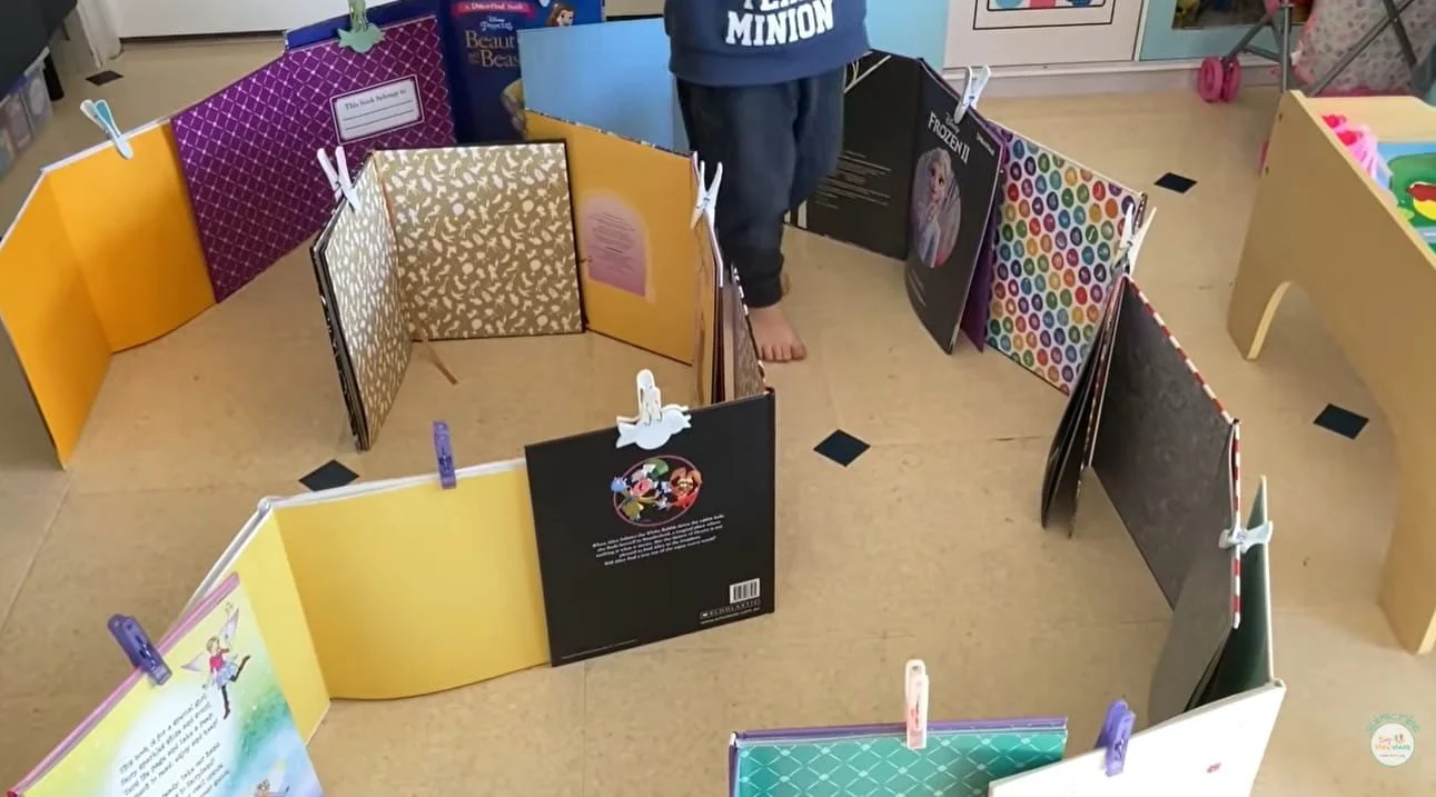 Child walking through a book maze in an obstacle course