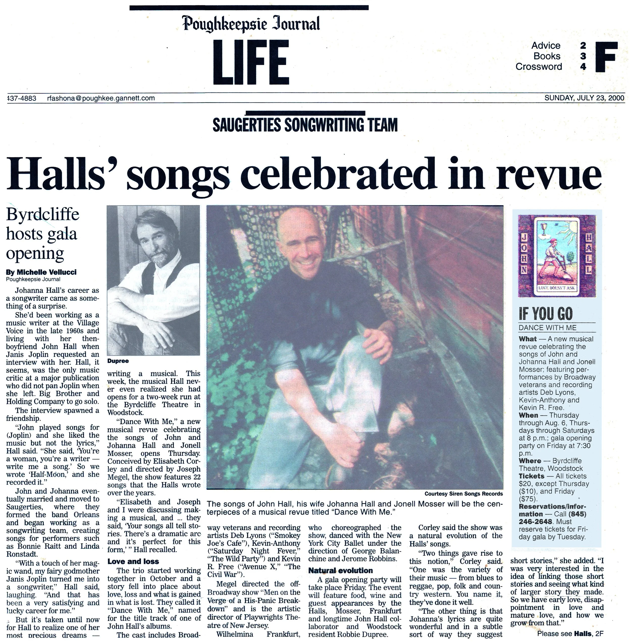 A newspaper article from the Poughkeepsie Journal titled "Halls' songs celebrated in revue", dated Sunday, July 23, 2000. The article features a large photo of a smiling man with a shaved head, seated in front of colorful fabric, and a smaller photo of a man with dark hair and a beard. The article discusses a musical revue celebrating songs by Johanna Hall and Jonell Mosser, and includes various details about the production.