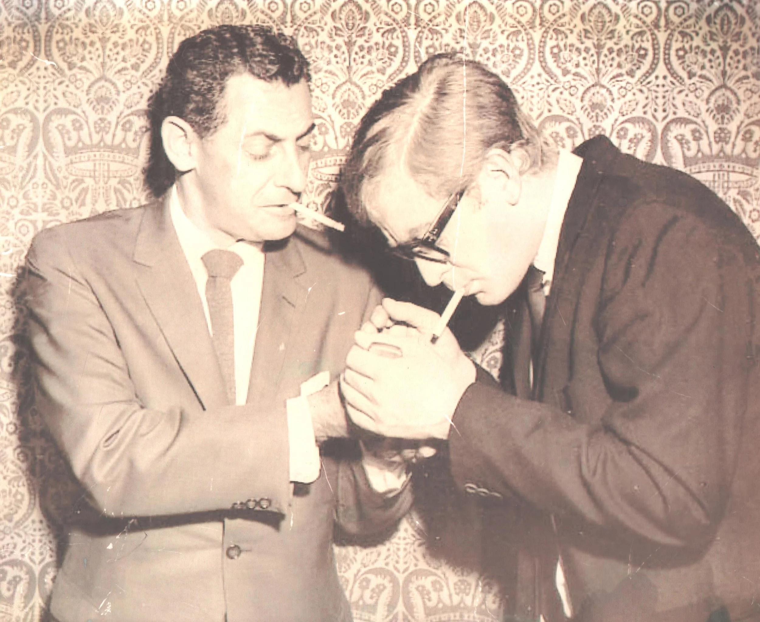 My father lighting a cigarette for actor Michael Caine at some Hollywood event.