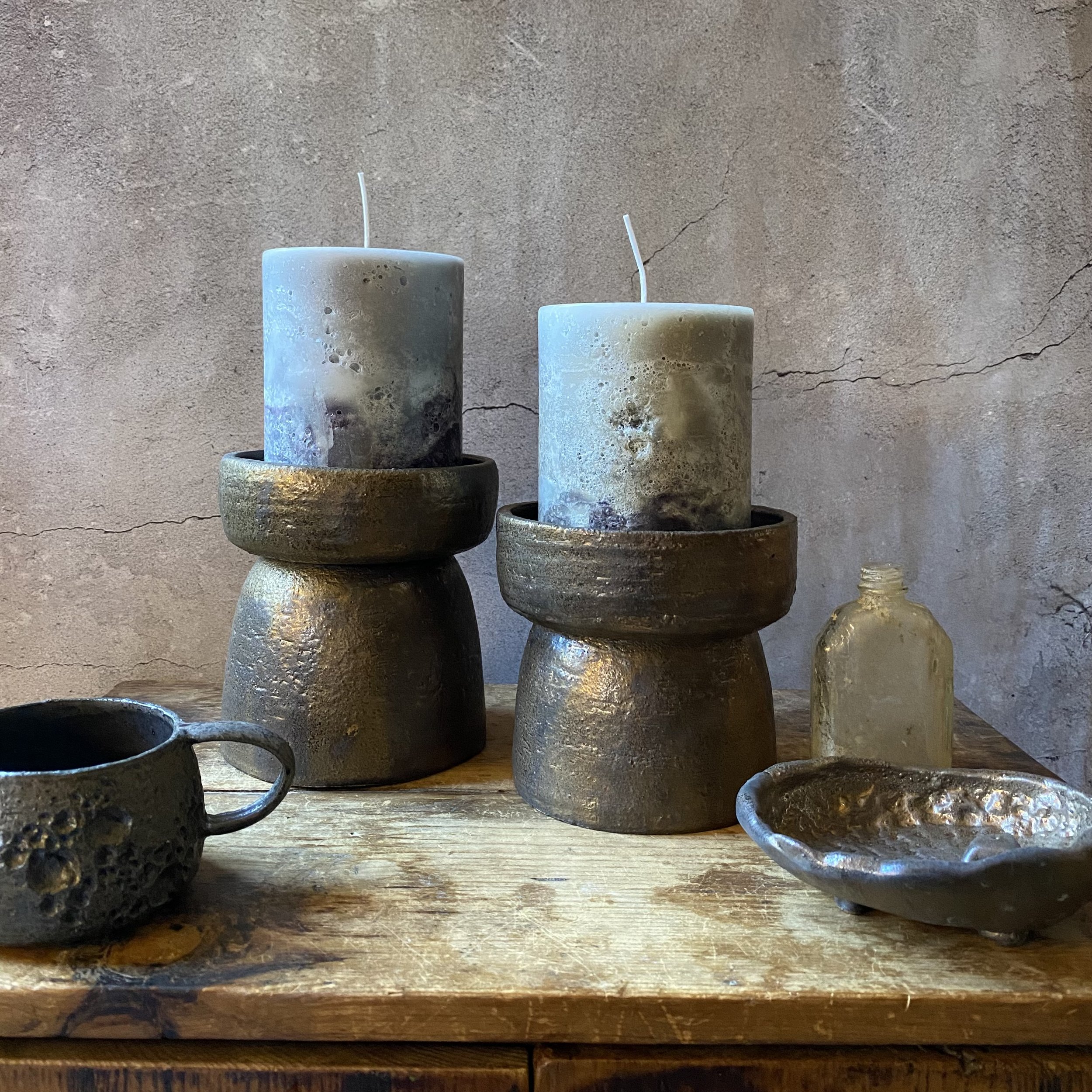 Unearthed handmade ceramic candlestick holders in bronze