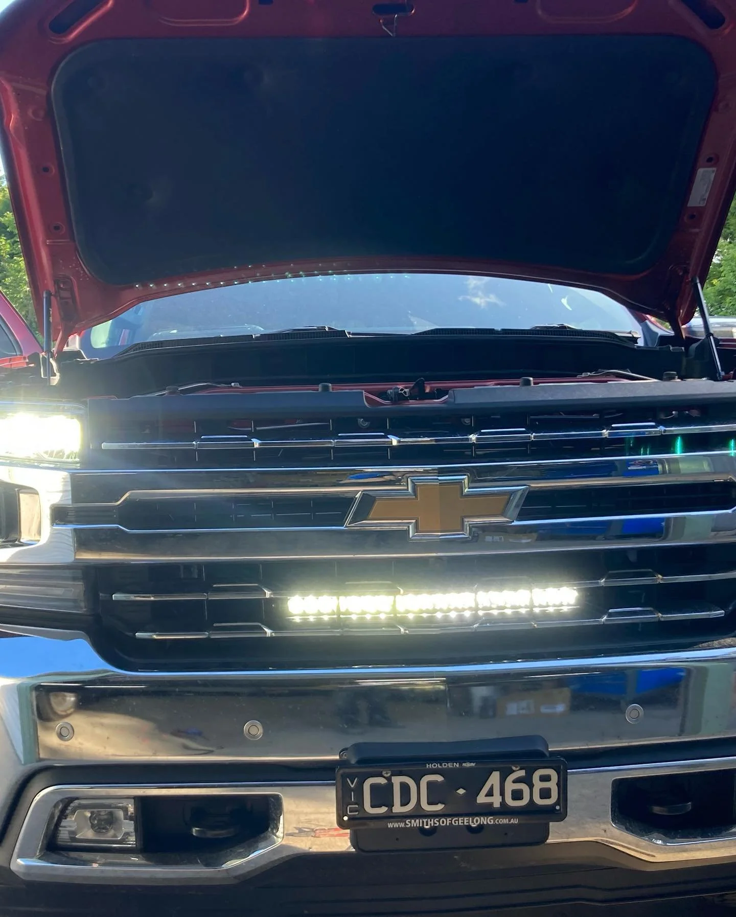 Silverado 1500 set up for off grid camping with lithium auxiliary battery under the back seat as well as light bar, uhf and caravan wiring