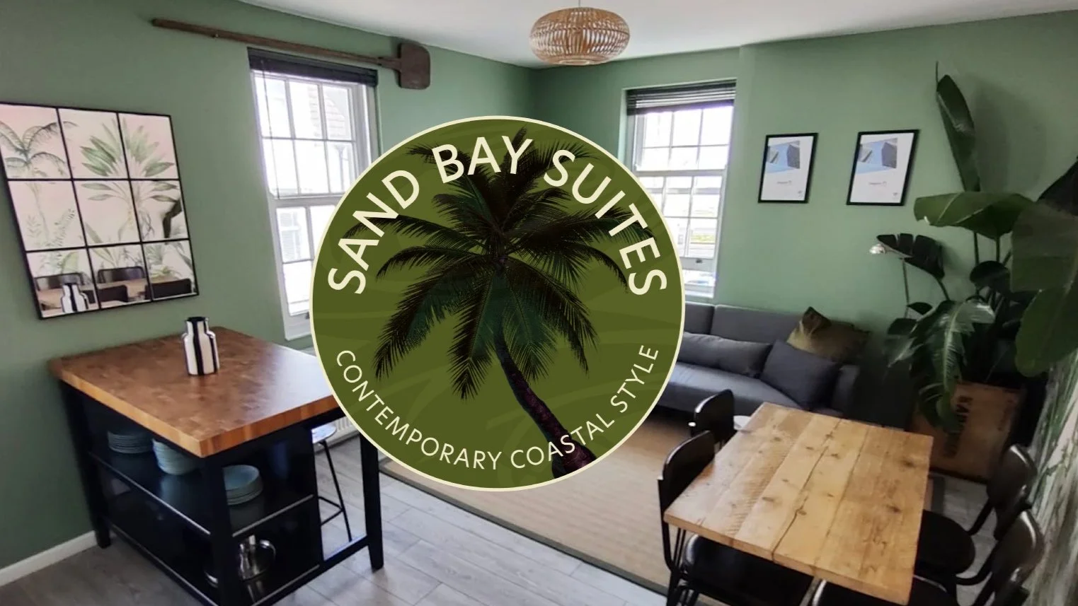SAND Bay Suites logo on an image of the Air B&B lounge space.