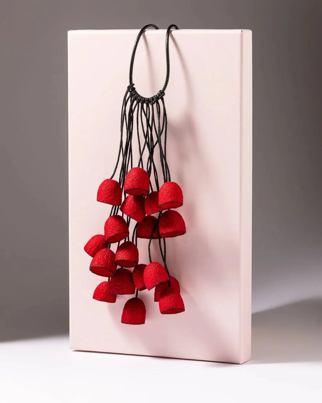 Silk, shaped by hand.

Made from real silkworm cocoons, this necklace is crafted by Gulnara, a Florence-based artisan working within centuries-old silk traditions. The palette &mdash; ochre, black, red, blue &mdash; is drawn from natural dyes and qui