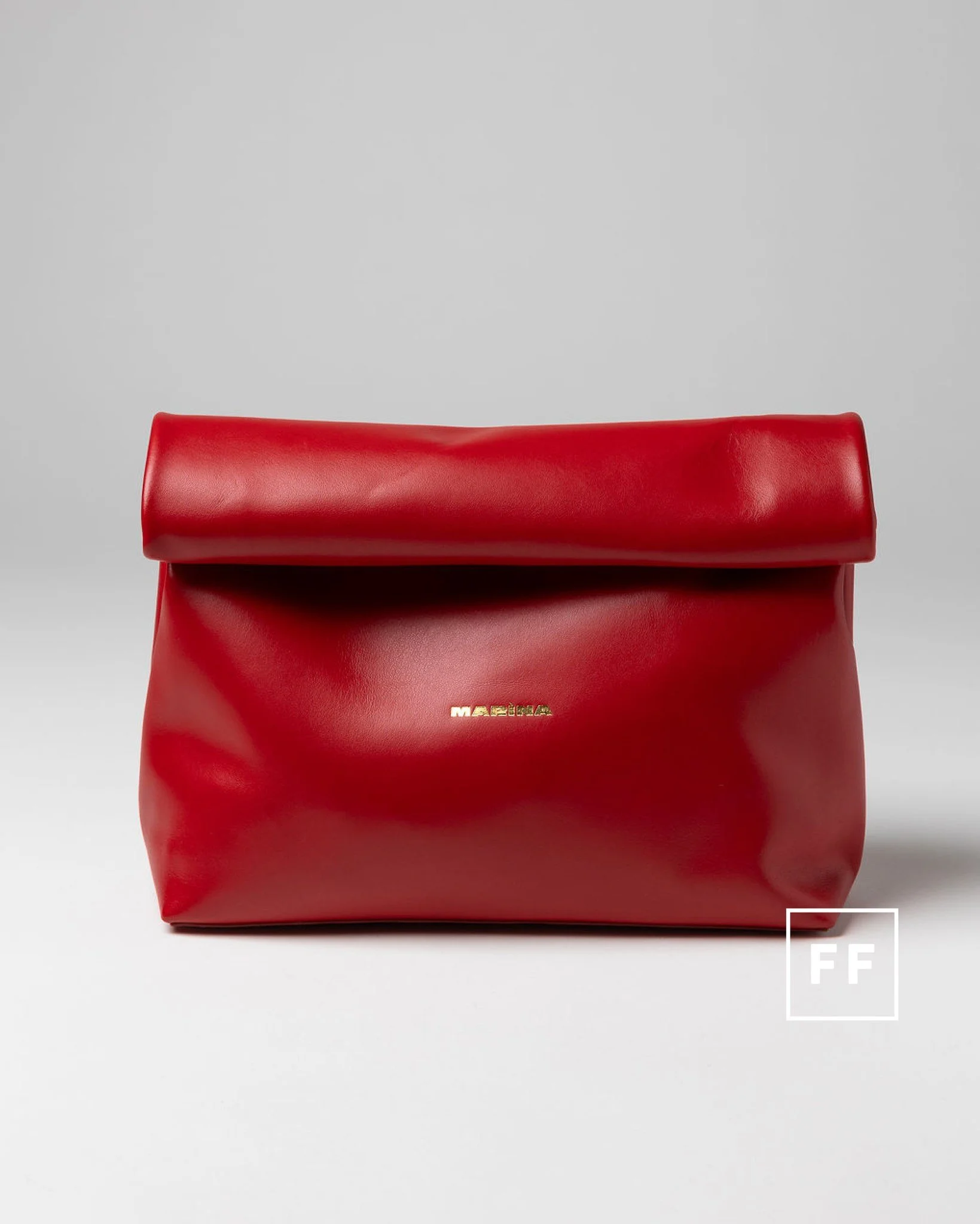 Meet the leather bag inspired by the humble paper lunch bag&mdash;only sharper, richer and far less disposable.

Handmade in Italy, it pairs a compact silhouette with surprising capacity, a structured double base and a rolled handle secured by a doub
