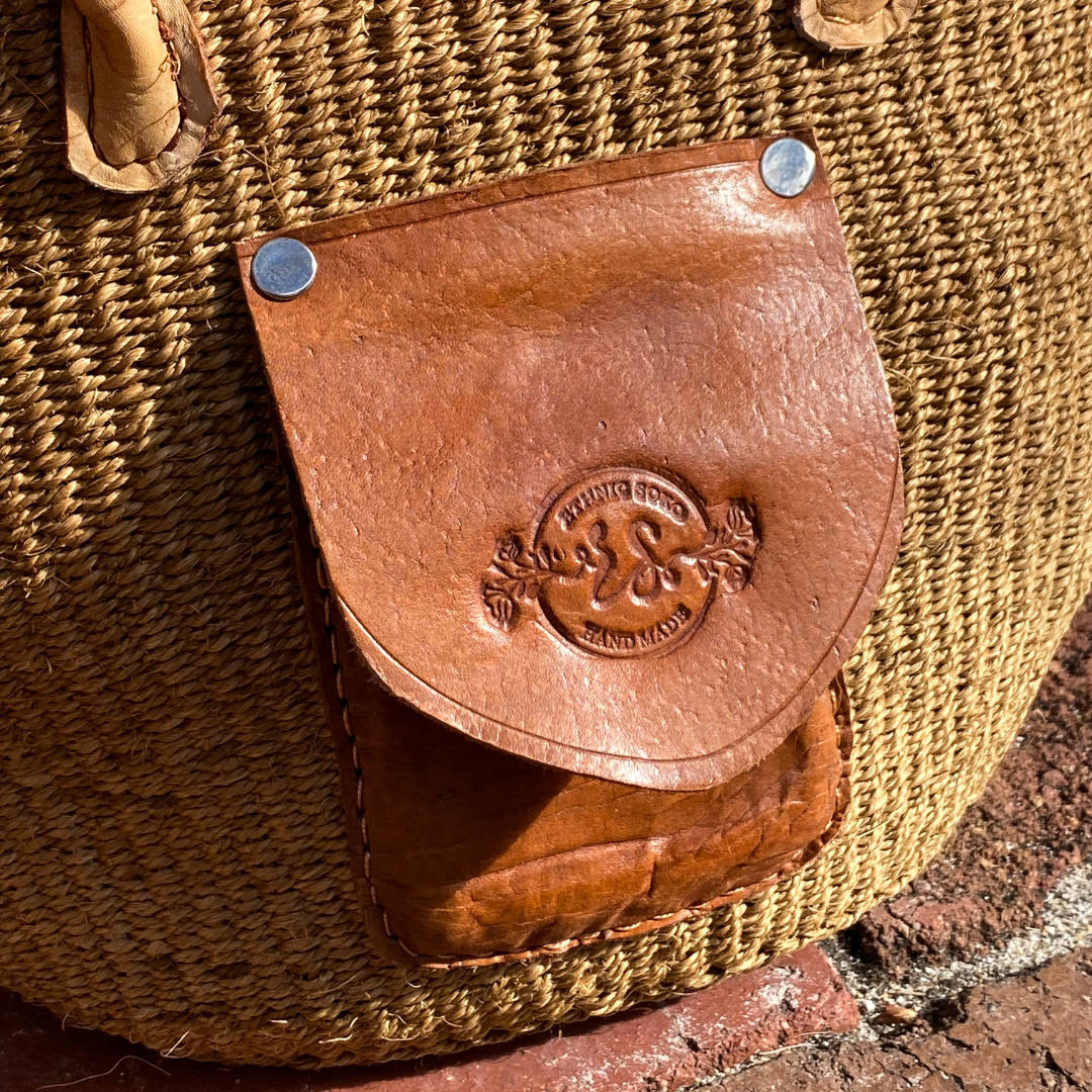 Handmade sisal handbag with genuine leather straps. Extra leather pocket on the side.