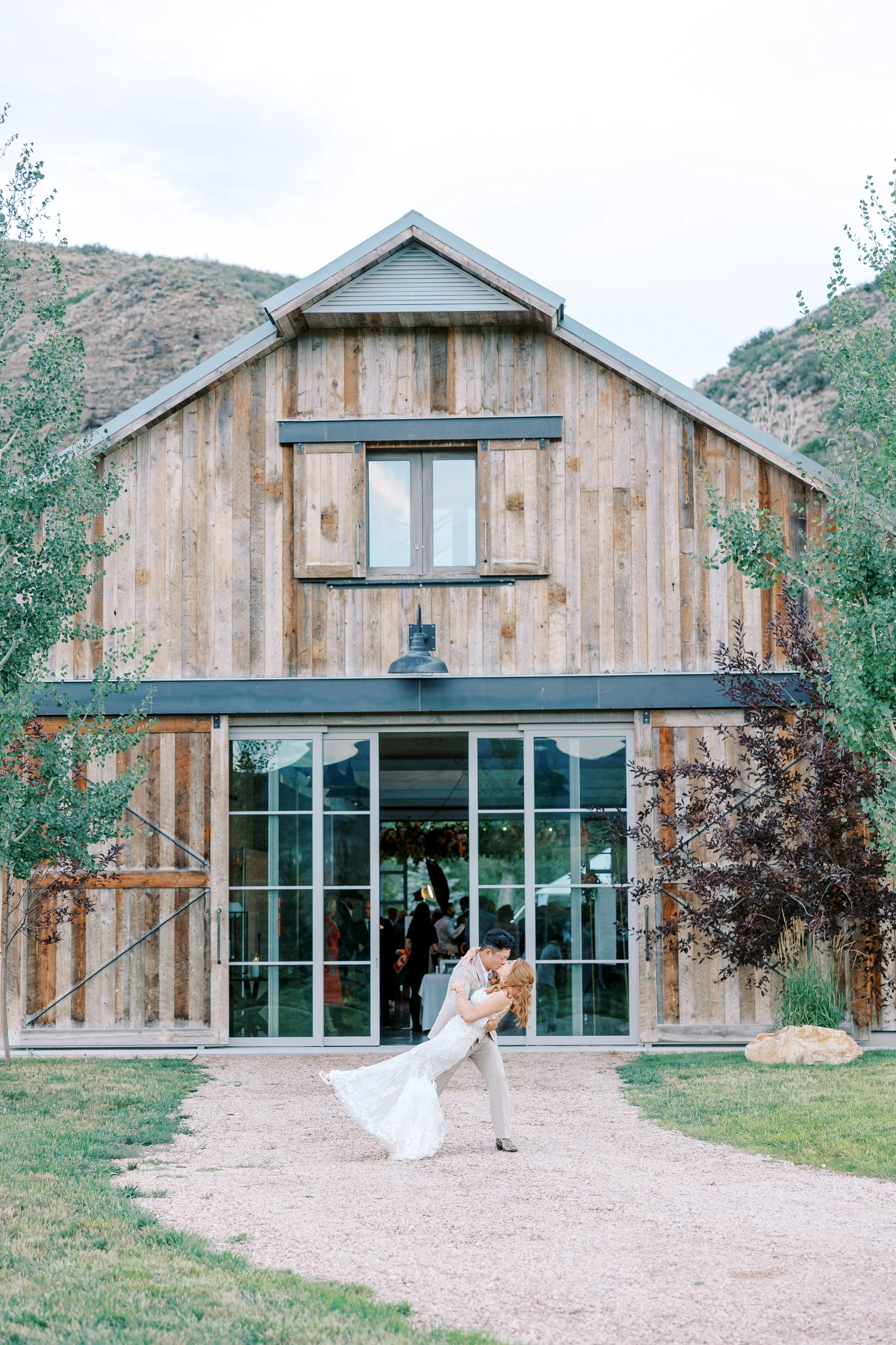 Bride and Groom Kissing in front of 4U Ranch wedding venue in Peoa, Utah