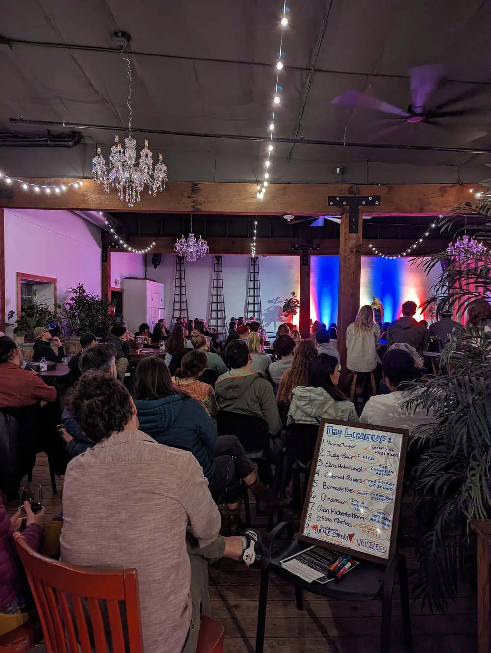 A storyteller on the mic at the Gorge Speakeasy