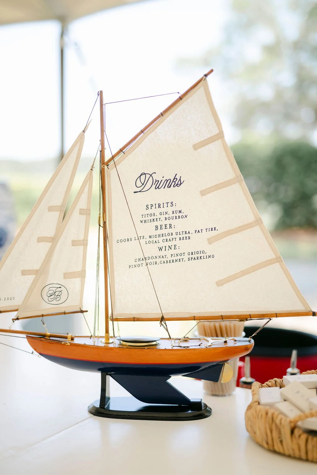 Custom sailboat bar sign with printed drink menu for coastal wedding at Oldfield South Carolina by Hartsy Designs