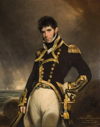 Painting of Gilbert Heathcote, a youngish man with curly black hair and Regency sideburns, wearing full Post Captain dress uniform and pulling an extremely sassy pose - one hand on hip, hips thrust forward. Background shows a stormy sky and sea.