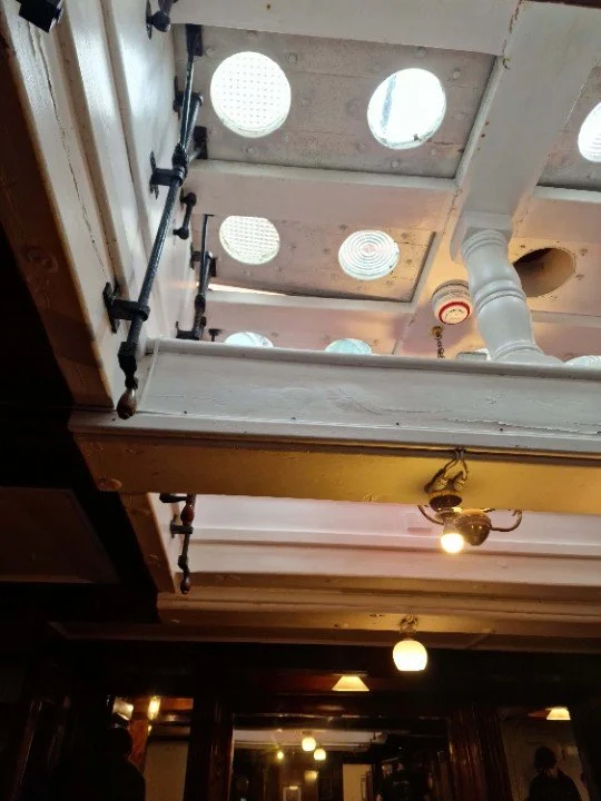 A set of deck prisms seen from below: quite a lot of light shines through them.