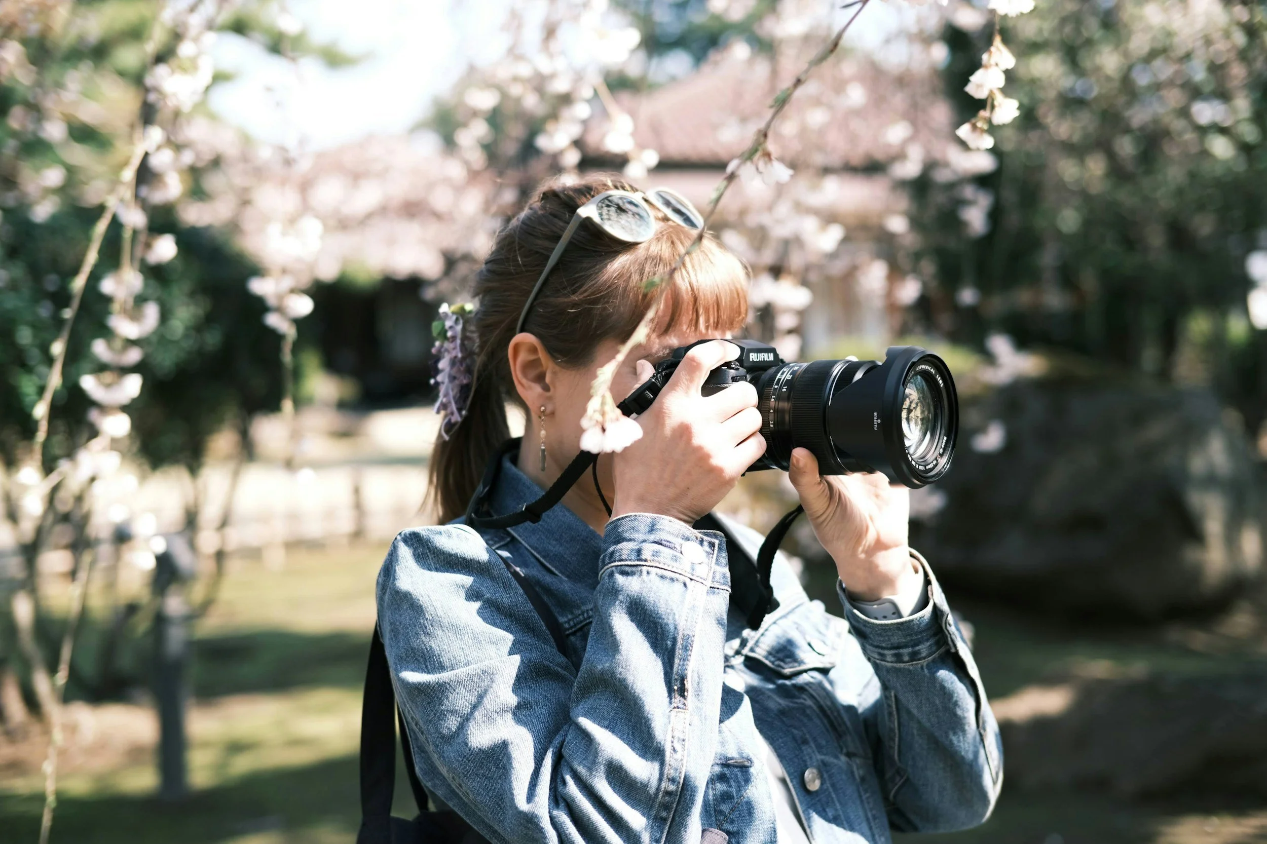 A woman taking pictures for her garden center's content calendar.