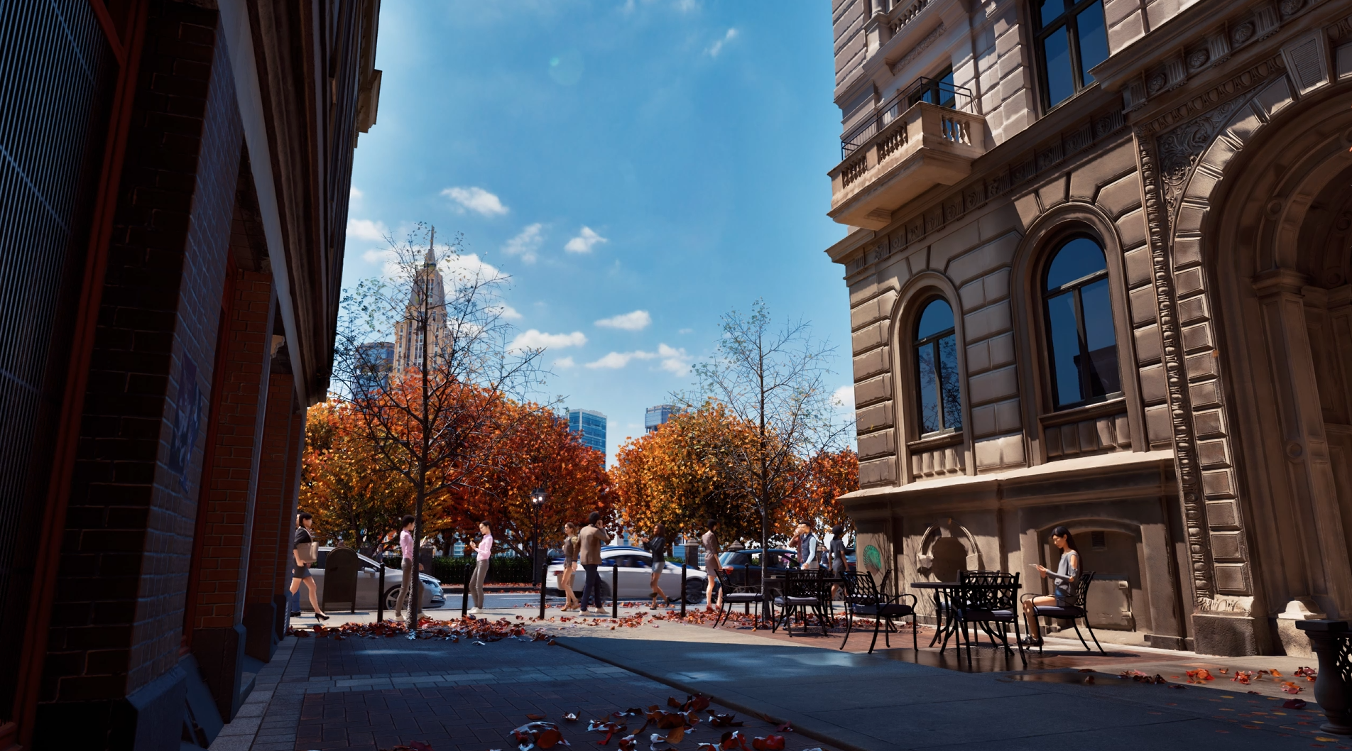 City street scene with people walking on the sidewalk, autumn trees, historic building with ornate facade on the right, and skyscrapers in the background under a blue sky.