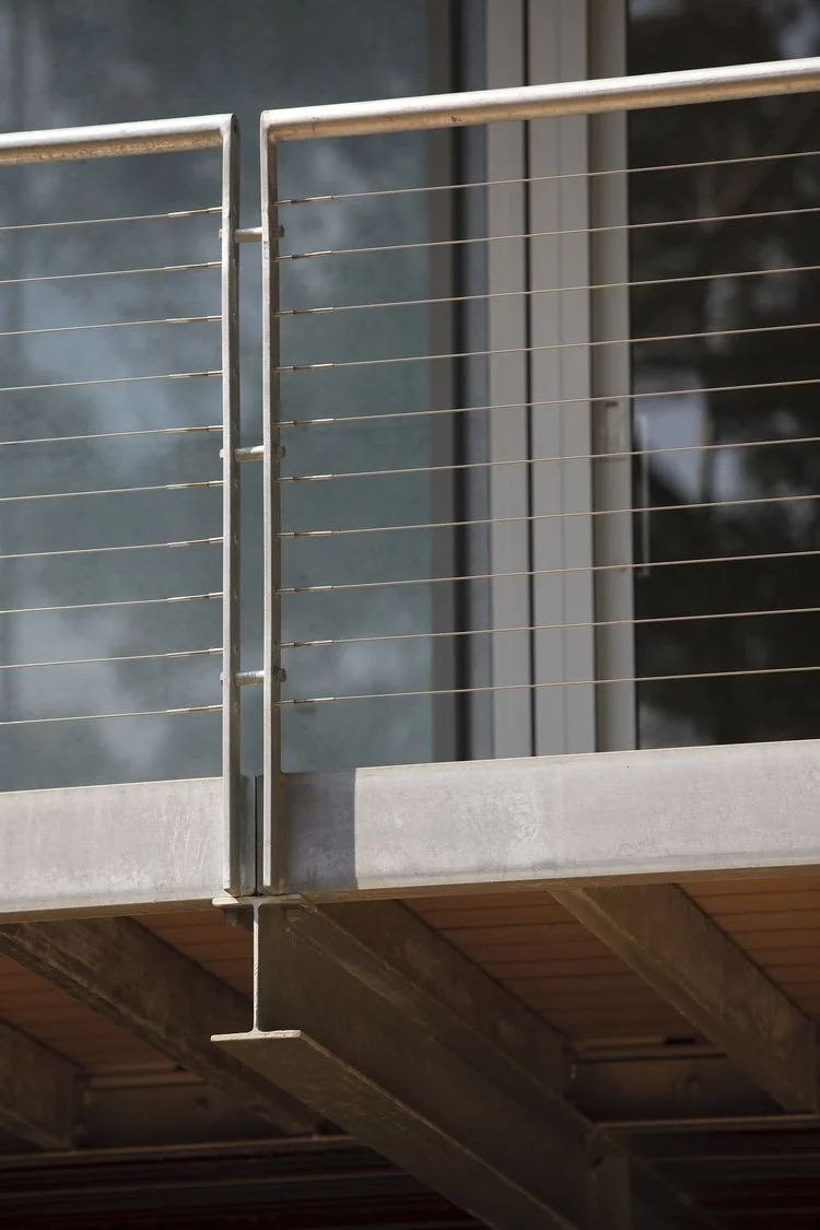 #15 Round tubing handrail with flat bar posts and cable paneling