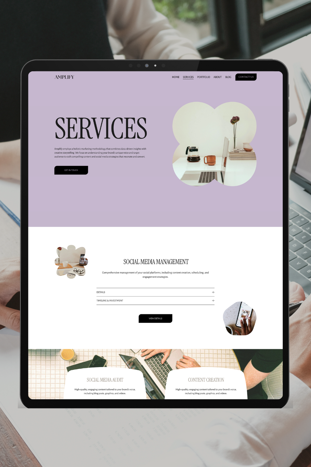 A person using a laptop displaying a website for a marketing agency called AMPLIFY, featuring services like social media management, social media audit, and content creation, with a purple and white color scheme and images of a workspace.