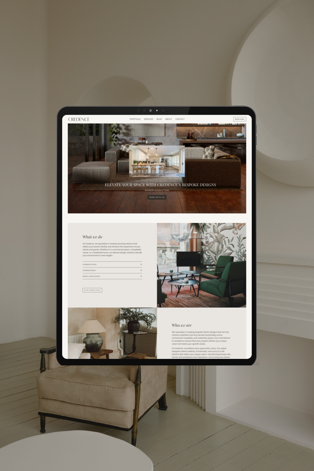 A digital tablet displaying a website for Credence interior design, featuring images of modern interior spaces, a header menu, and service descriptions.