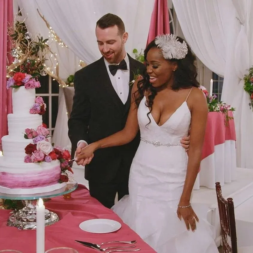 lauren speed-hamilton and cameron hamilton from the reality TV show love is blind cutting a piece of their wedding cake in 2018 after getting married