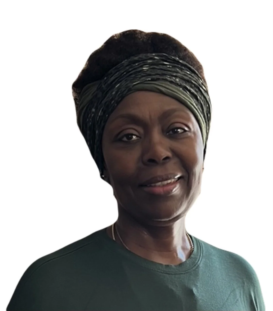 A woman wearing a green headwrap and matching green shirt, smiling softly.