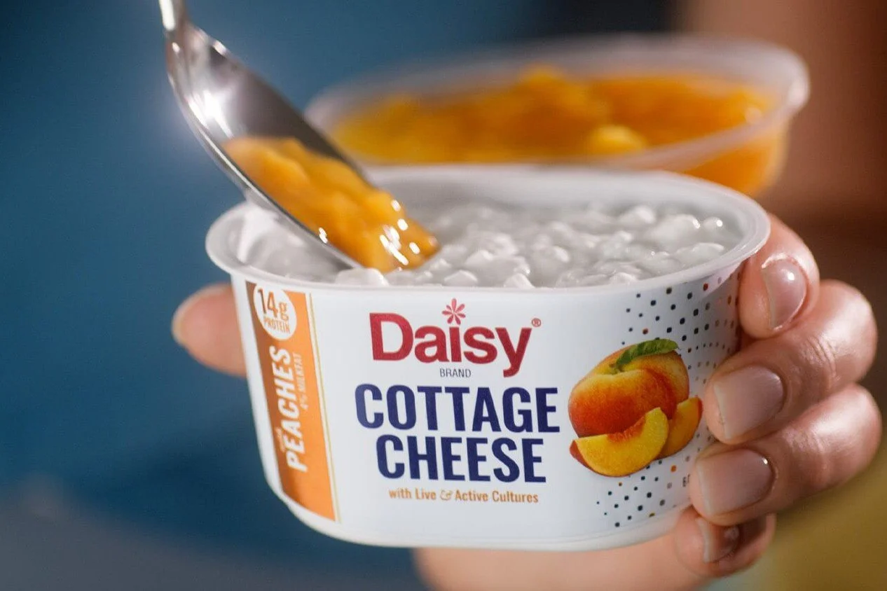 daisy-cottage-cheese-lifestyle-new-package-peaches-uai-1266x844.jpg