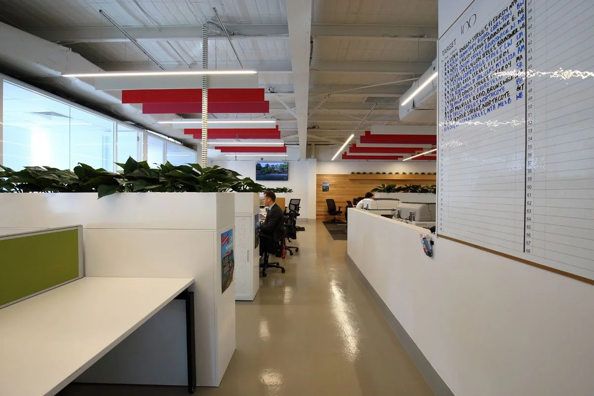 Hocking Stuart office space with a white board and green and red accents