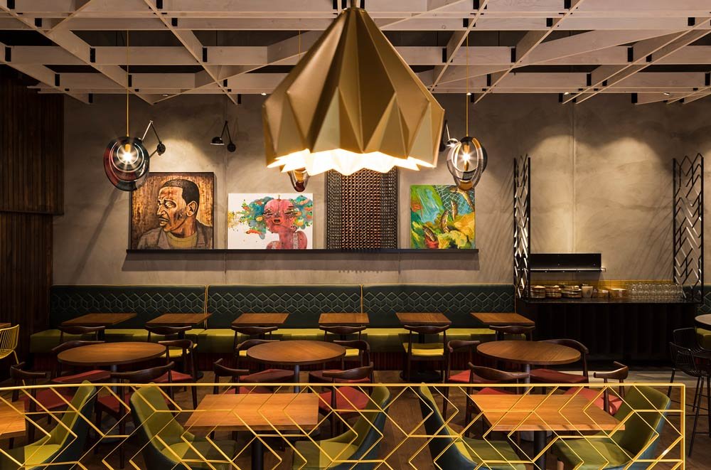 Nando's seating area with pendant light and art on the back wall