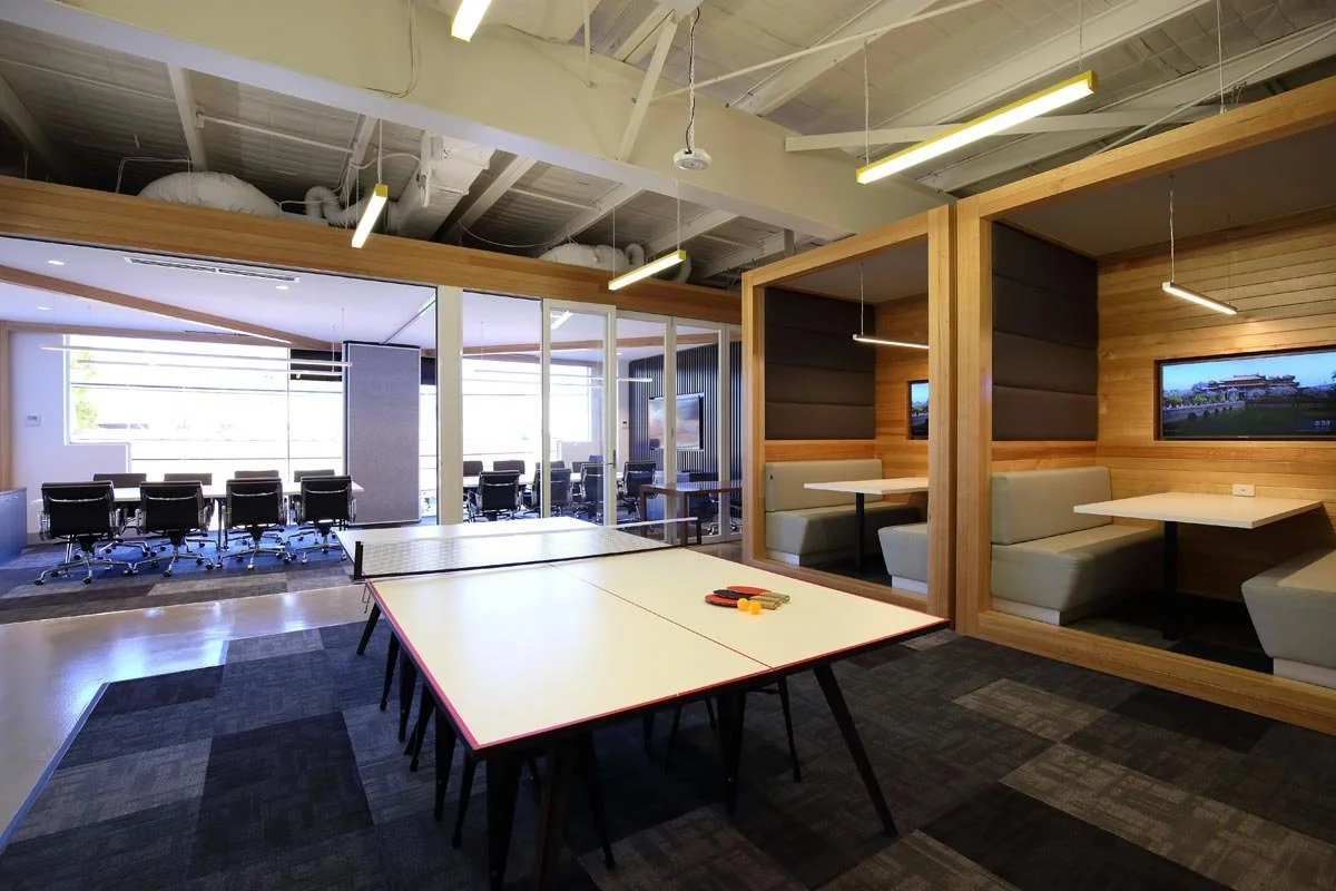 Hocking Stuart ping pong table next to a glass board rooms and two private booths