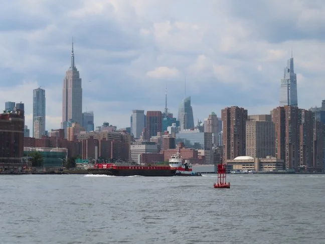 Tugboat passing us on the East River, with Empire State Building on left