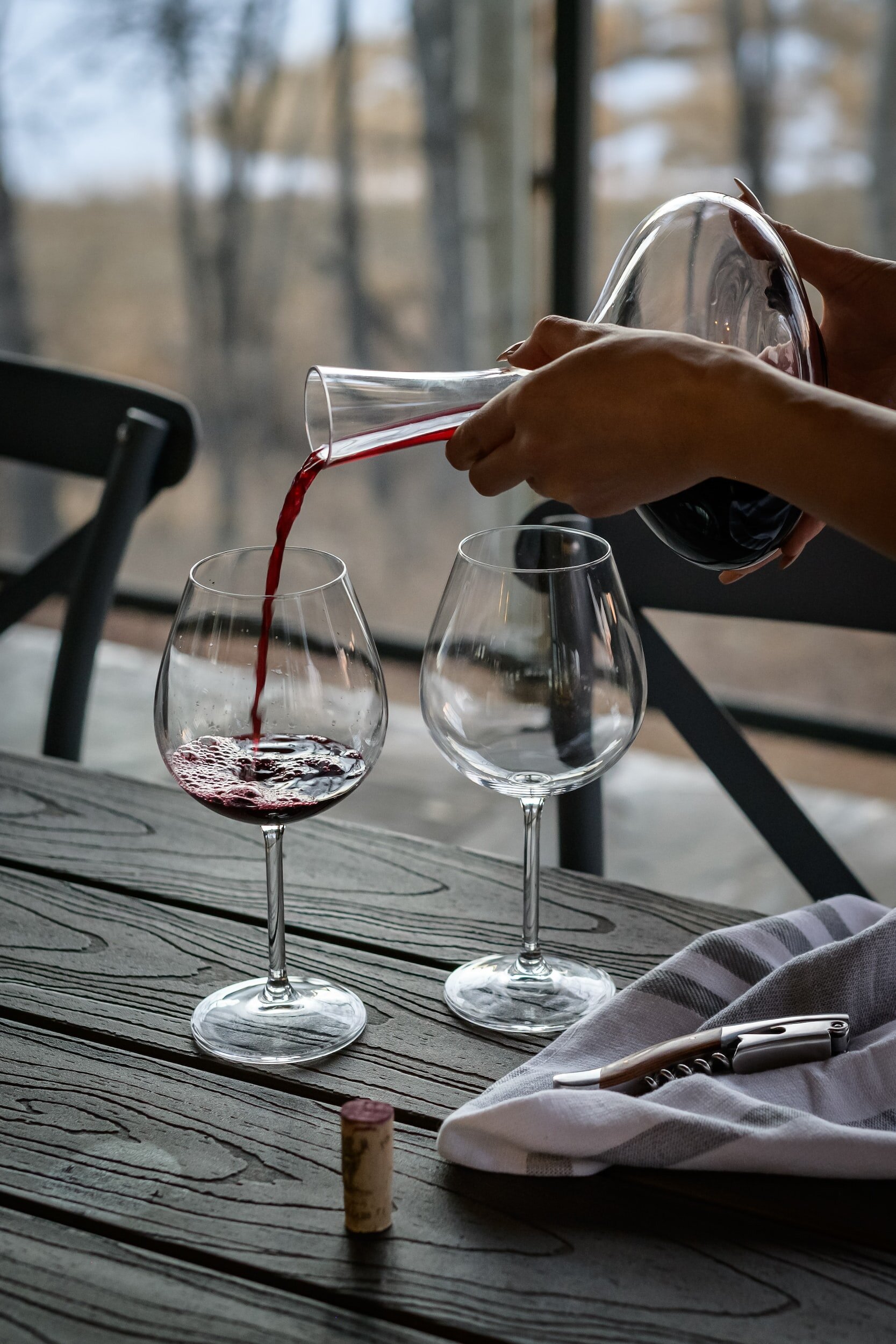 Pouring wine into glasses from a carafe
