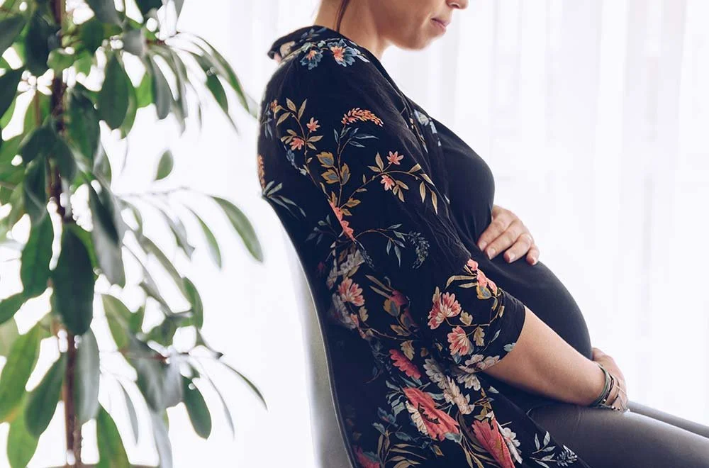 A pregnant lady waiting in west end wellness waiting from before being treated with a acupucnture treatment