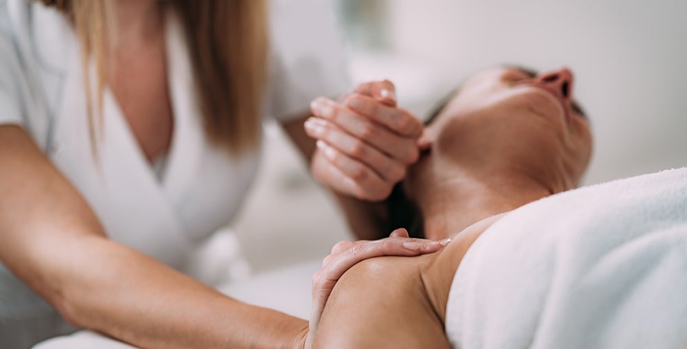 Registered massage therapist performing deep tissue massage to release muscle tension at West End Wellness Vancouver.