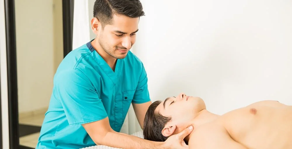 Massage therapist using forearm pressure on client’s back, demonstrating hands-on skills learned in RMT programs in BC.