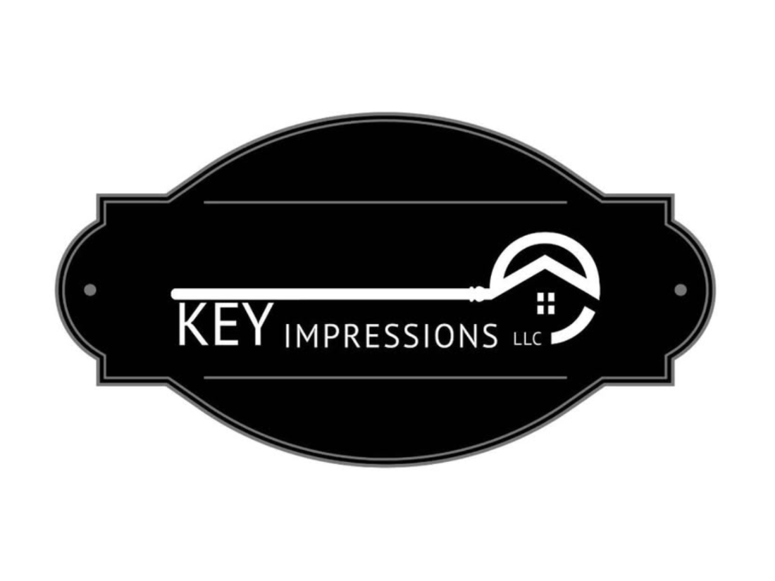 Black and white logo for KEY IMPRESSIONS LLC with an image of a key incorporating a house roof and window.