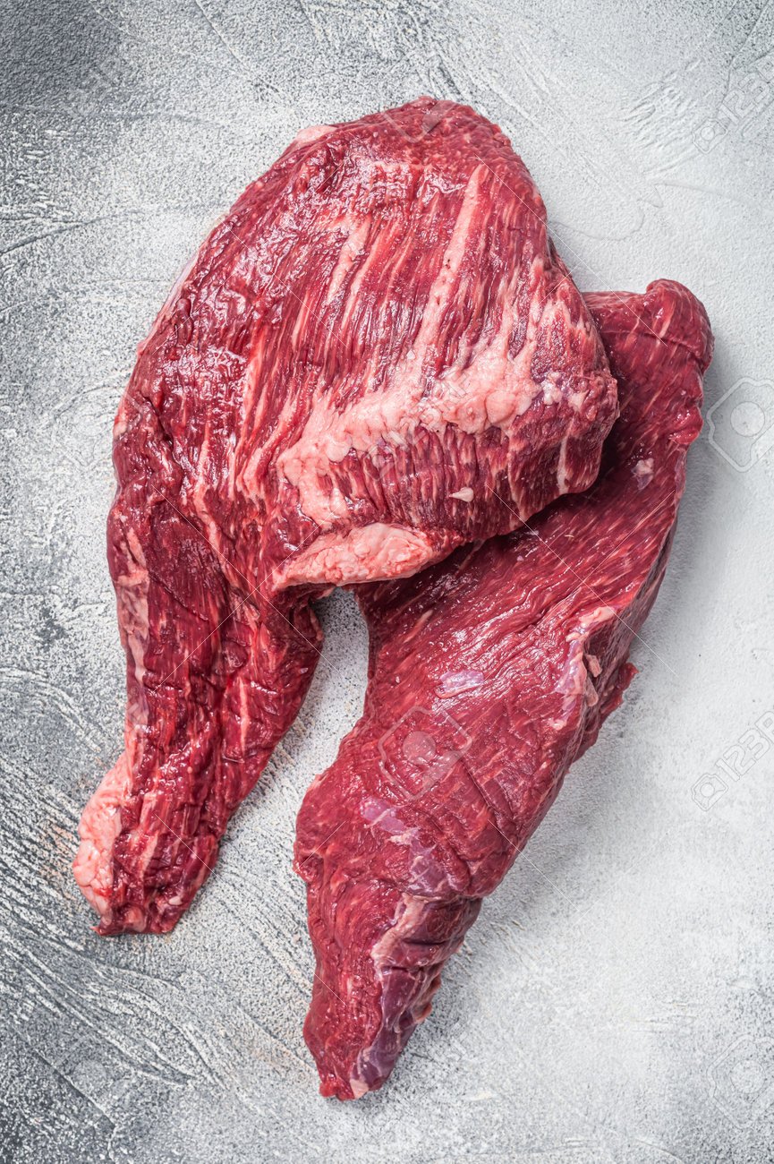 188497149-raw-tri-tip-beef-steak-on-kitchen-table-white-background-top-view.jpg