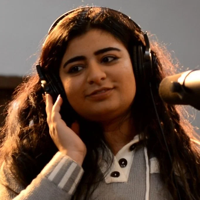 Person with headphones in recording studio