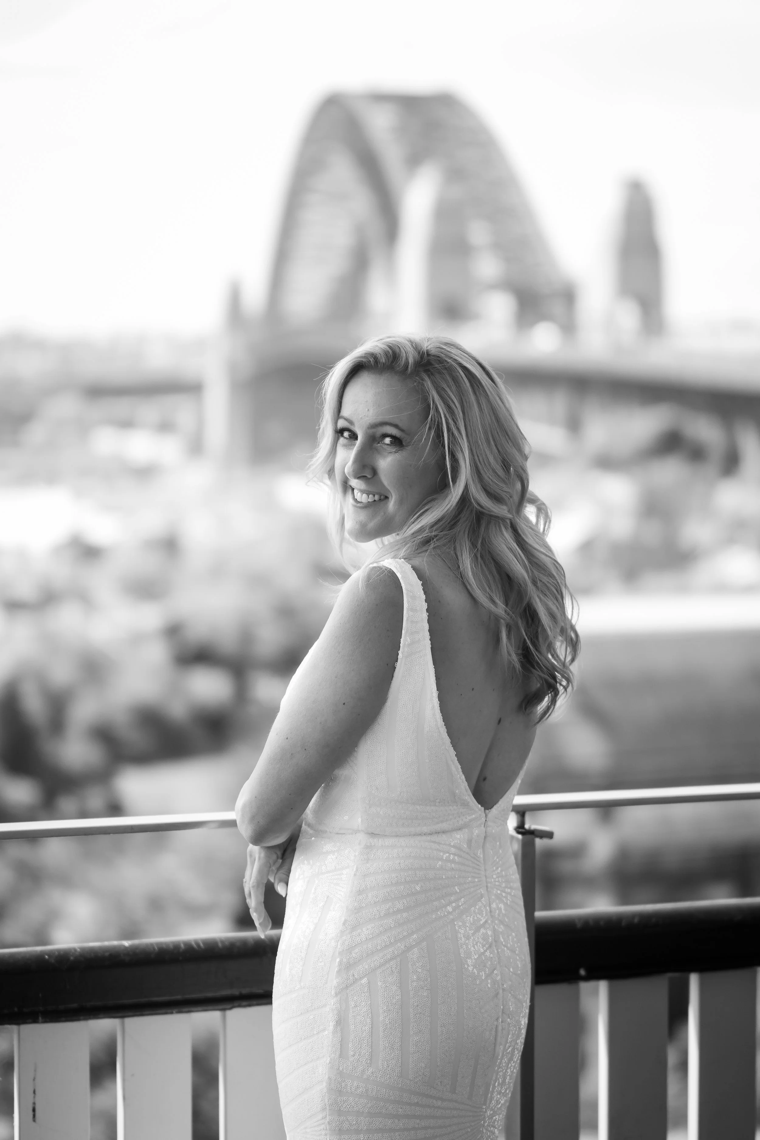 Bride looks over her shoulder at Observatory Hill with the Sydney Harbour Bridge behind her