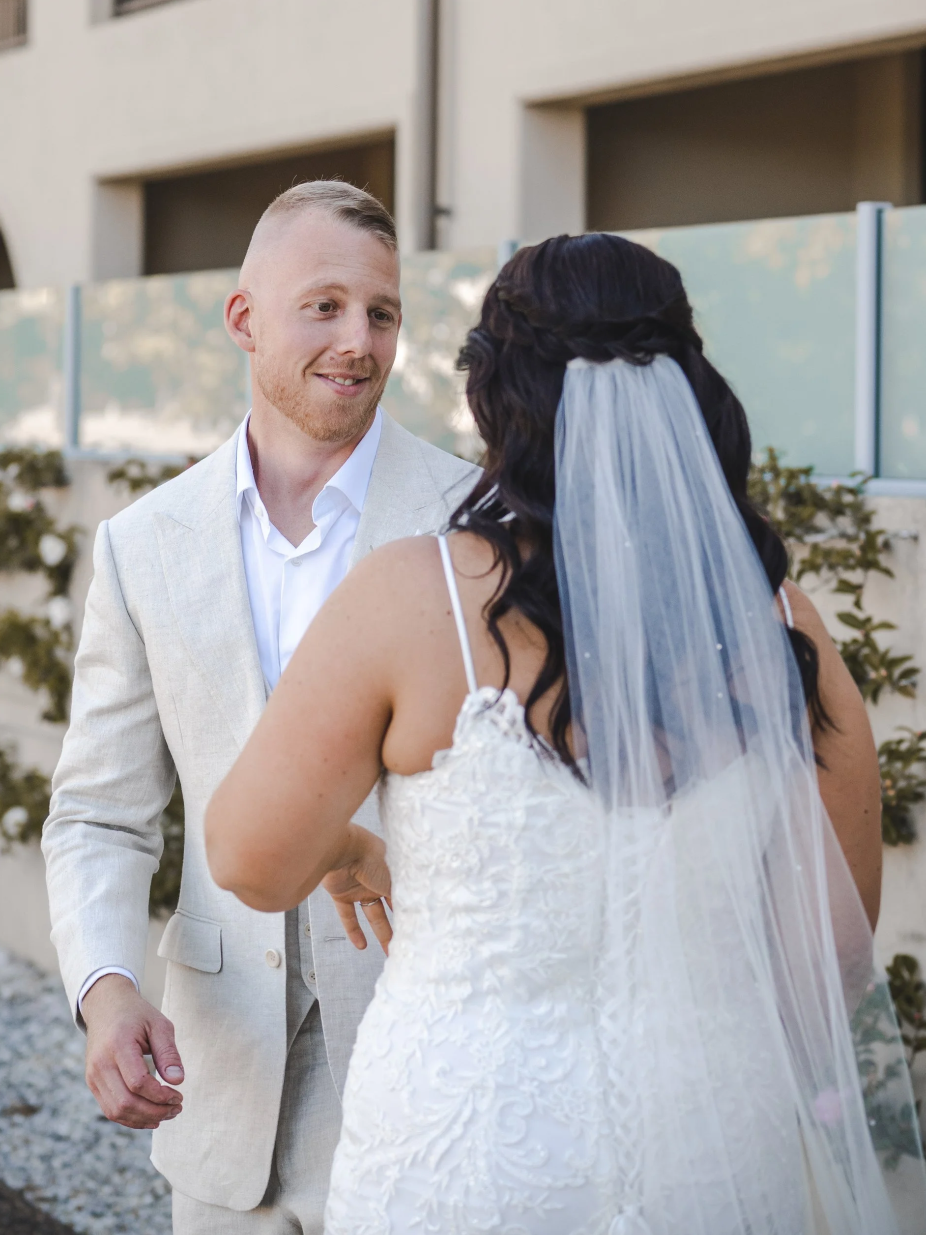 Groom smiles as he sees his bride for the first time during their first look at Château Élan in the Hunter Valley