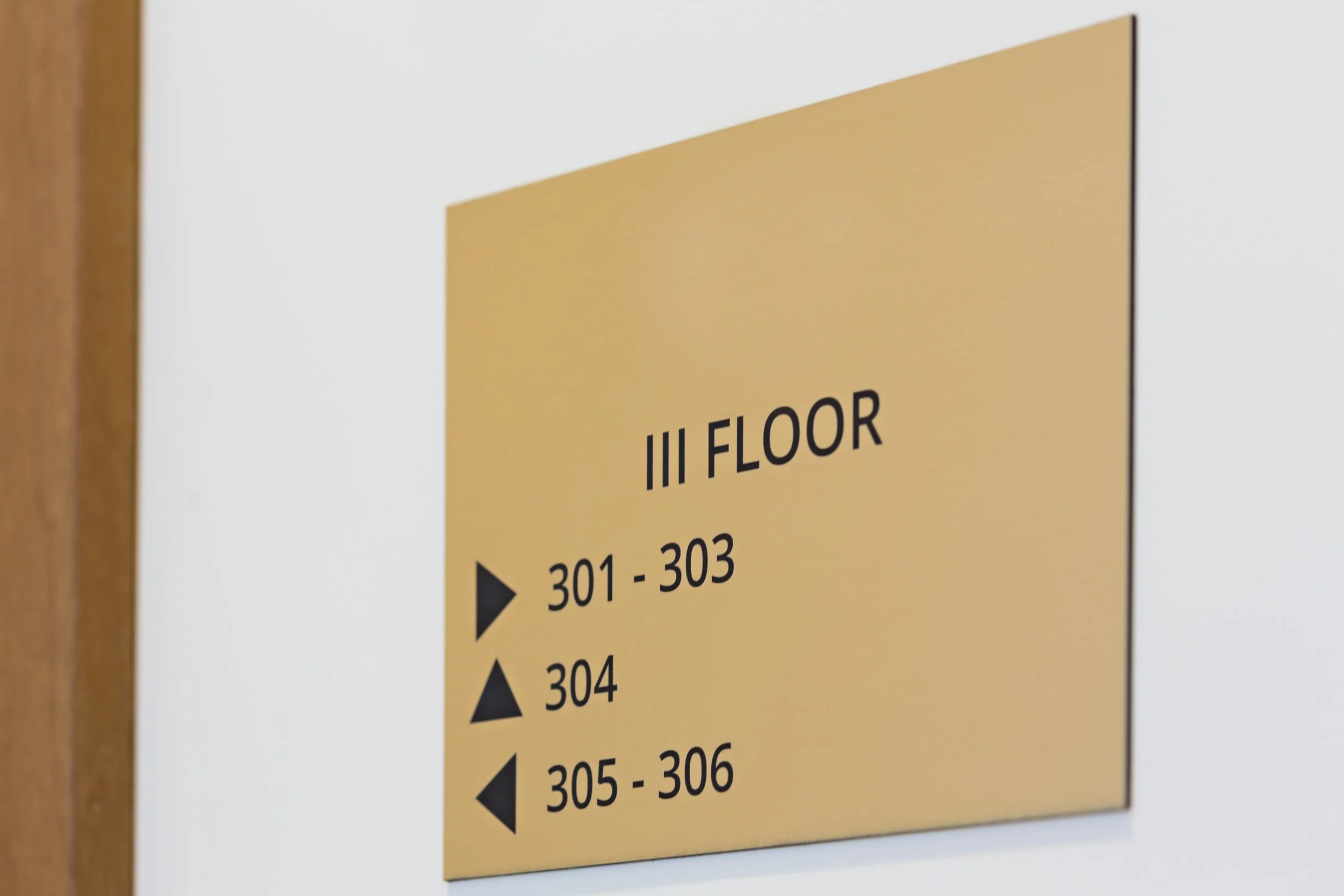 A digital directory sign displaying the number 4 and the name 'Golden Village' in a shopping mall or entertainment complex, with escalators and a glass ceiling overhead.