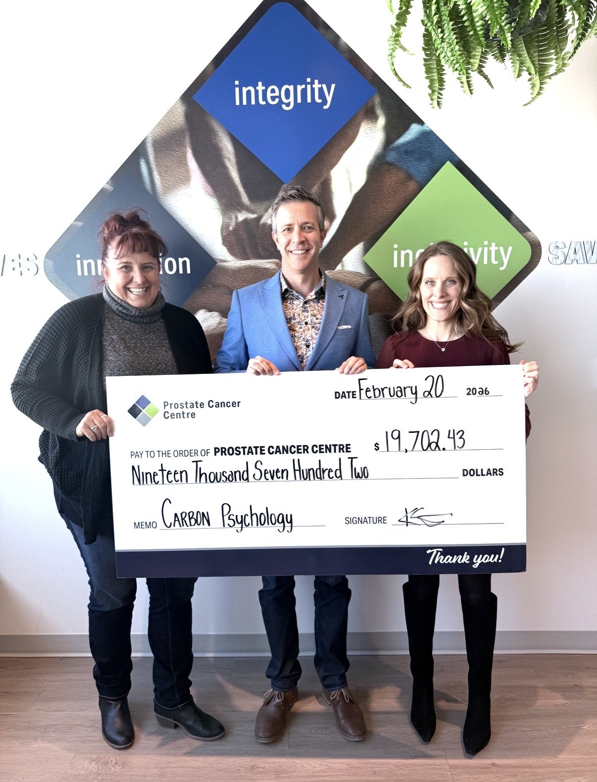 CEO of Carbon Psychology holding a cheque with the Prostate Cancer Centre CEO for the money she raised.