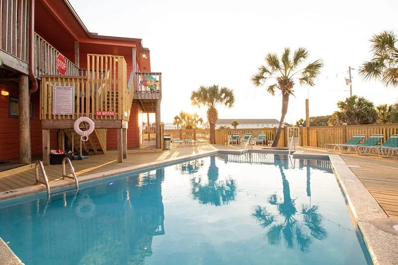 Private swimming pool for your group right outside of your rooms. Large seating areas with patio furniture on either side of the pool.