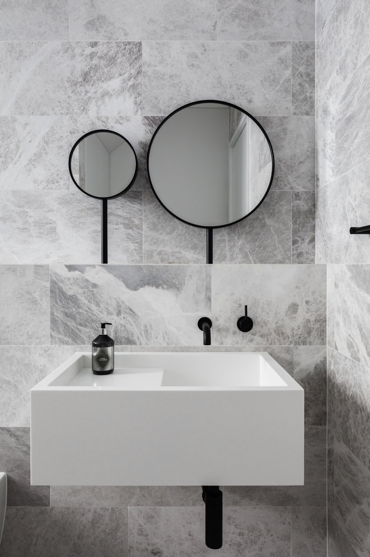 Gray Marble Bathroom Wall Tiles With Brick Tile Pattern Round Black Frame Vanity Mirror And Black Bathroom Faucets