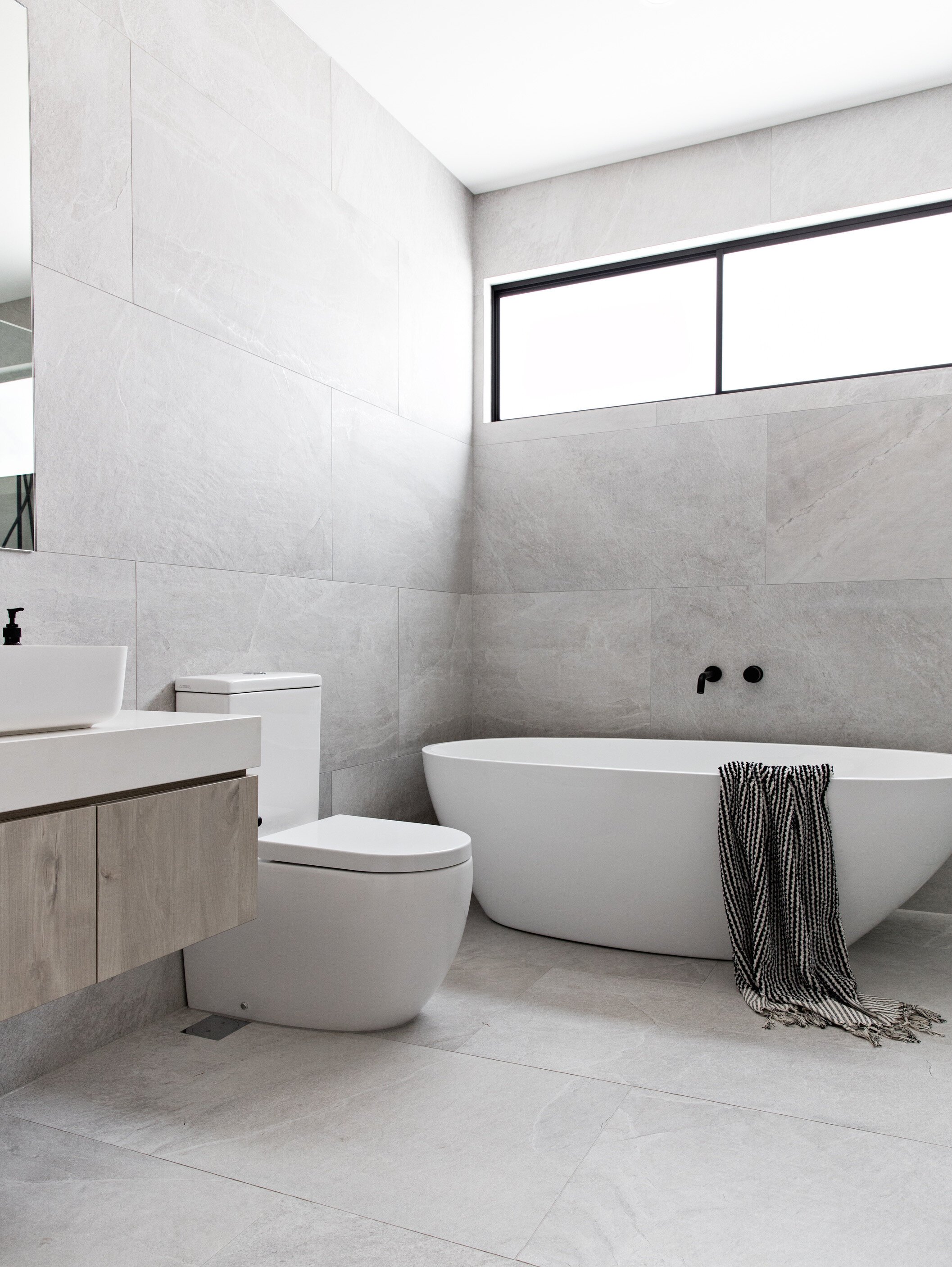 Scandinavian bathroom design with large bathroom tiles and Scandi WC