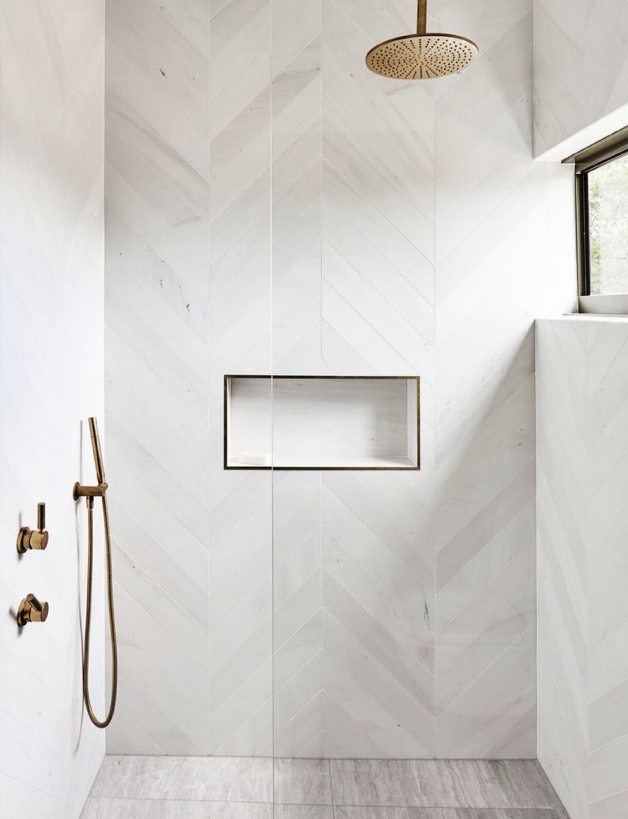 white tiles in the shower, laid in a chevron pattern