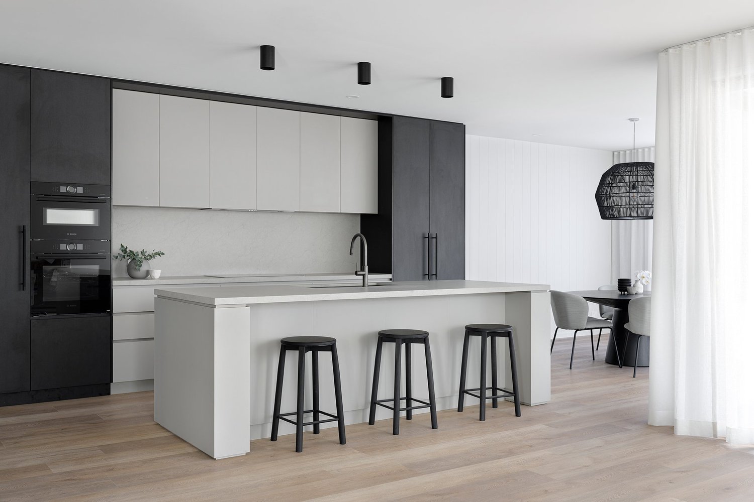 Fifty shades kitchen island bench with black barstools and timber wooden flooring for kitchen remodel