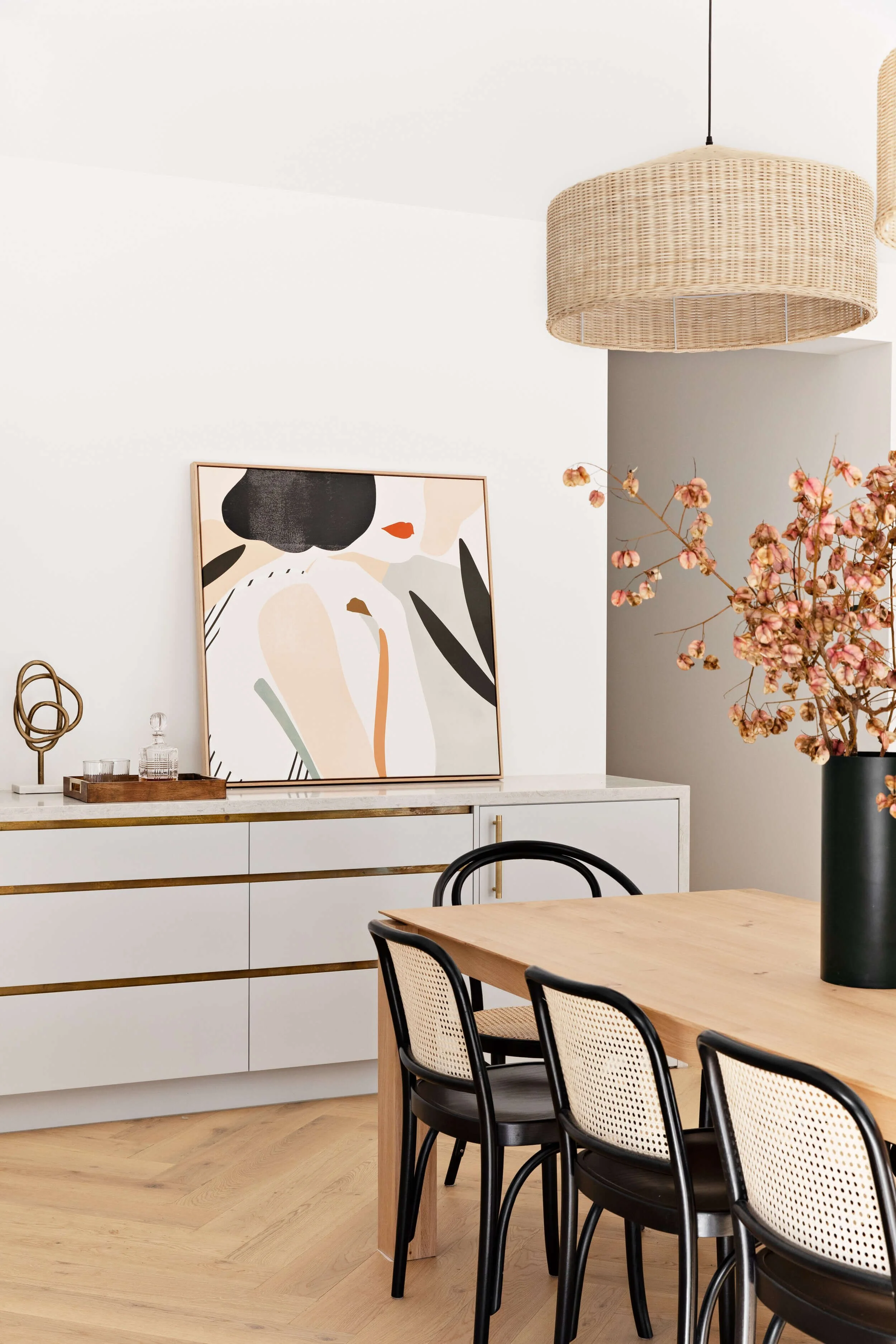 Dining room design with engineered wooden flooring and rattan pendant lights