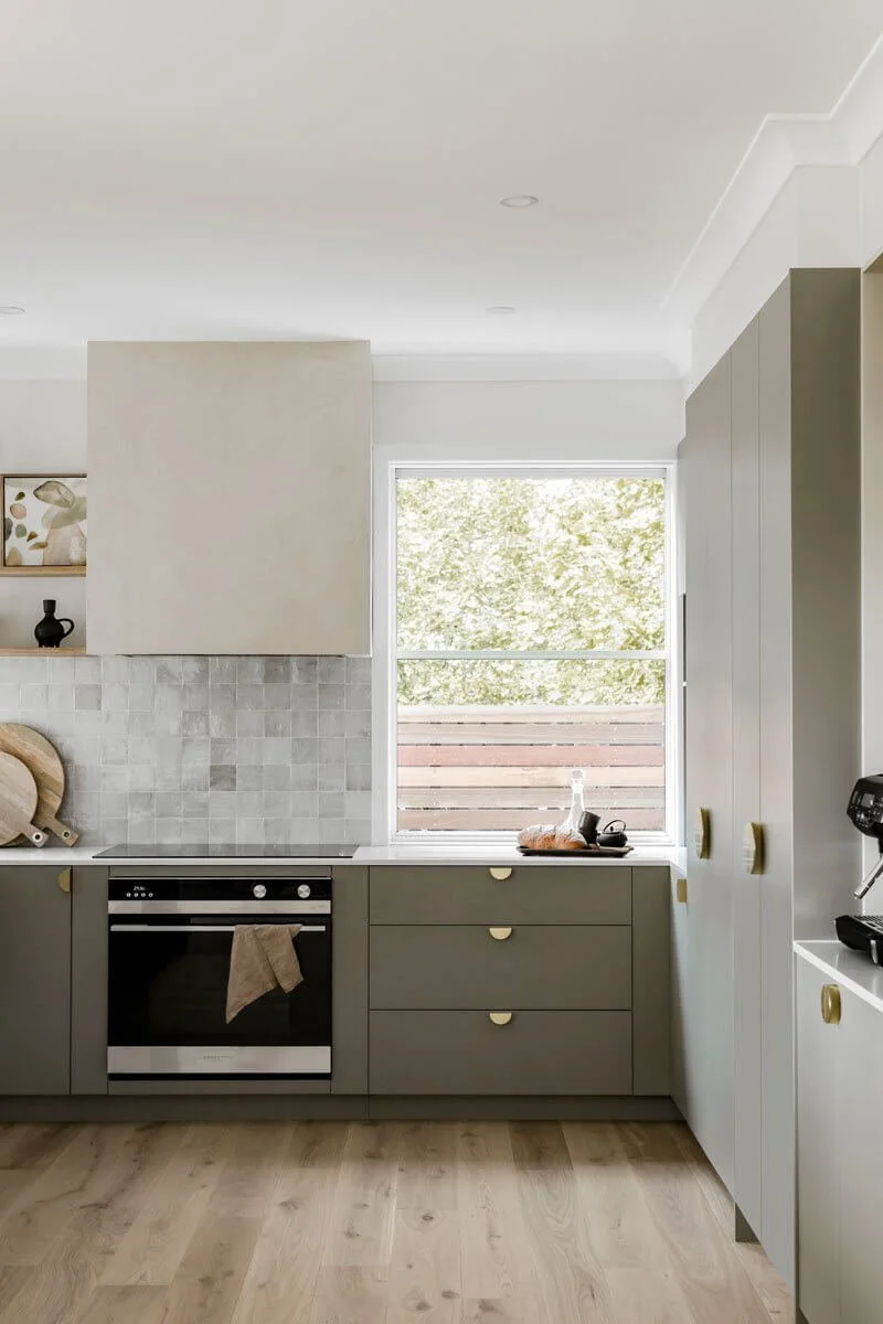 Kitchen design with marble wall tiles and wooden flooring